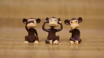 Three monkey figurines representing see no evil, hear no evil, and speak no evil, reflecting difficult political cho...