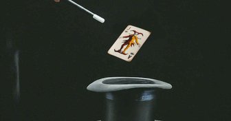 A playing card floats above a magician’s hat, symbolizing misleading promises and empty development claims in Baldwin County