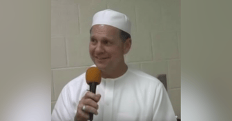 Roy Moore speaking into a microphone, despite past constitutional violations and removal from office