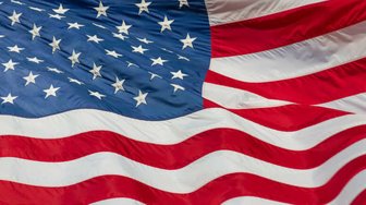 American flag waving against a dark background; reflects the upcoming midterms and questions about Baldwin County’s politi...