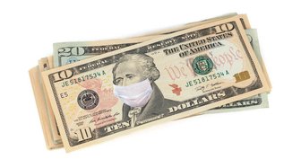 Stack of US currency with a $10 bill featuring George Washington wearing a face mask, referencing Fairhope’s waterfront pr...