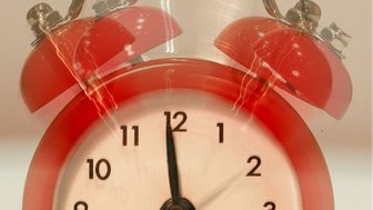 Alarm clock ringing, symbolizing Fairhope citizens urged to wake up regarding Airport Authority debt concerns