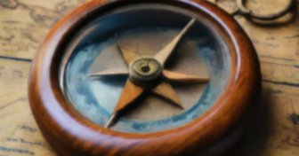 Antique compass on a map, symbolizing ethics and moral guidance lost by Fairhope City Council