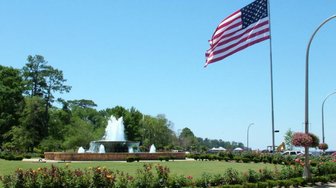 American flag waving over a fountain in Fairhope, Alabama, reflecting local voting patterns discussed in the article