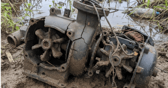 Grinder pump installed in a yard; often used by developers despite potential replacement costs and power needs for homeowners