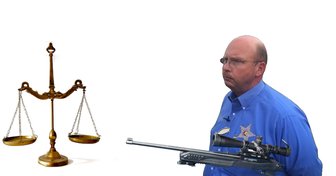 Sheriff Mack depicted holding a rifle next to scales of justice, symbolizing power and potential intimidation within Baldw...