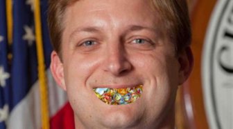 Fairhope Councilman Robinson depicted with marbles in his mouth, referencing criticism about his speaking style