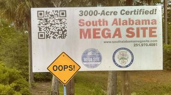 Sign advertising the South Alabama Mega Site in Baldwin County; includes QR code & contact info, alongside a humorous OOP...