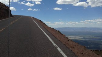 Road winding through landscape, symbolizing Alabama’s infrastructure challenges and potential loss of taxpayer funds due t...