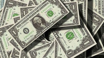 Pile of U.S. dollar bills, referencing concerns about financial interests influencing local politics and gas tax debates