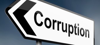 Road sign pointing towards Corruption, illustrating the article’s claim about widespread corruption in Alabama leadership