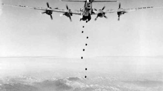 Vintage photo of a bomber dropping bombs over mountains, hinting at potential political fallout ahead of an election
