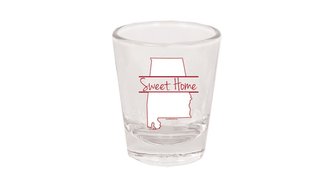 Alabama state-shaped shot glass labeled Sweet Home, symbolizing potential blind spots in reporting on local politics