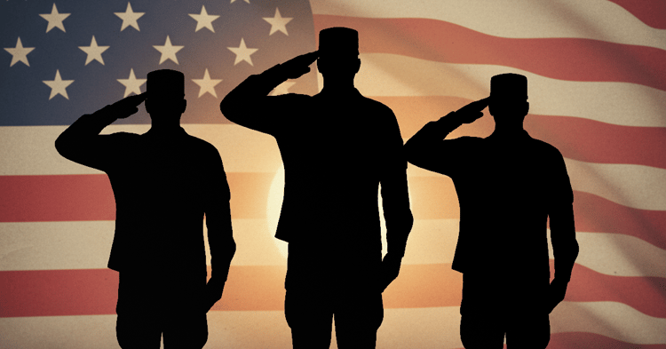 Veterans salute in front of an American flag backdrop