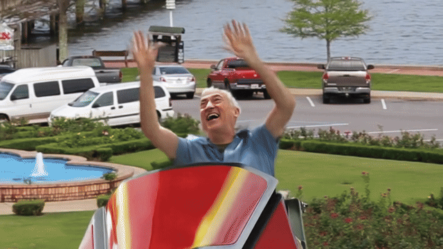 Man in a red boat waves enthusiastically near waterfront development delays impacting Fauxhope city projects - Animated